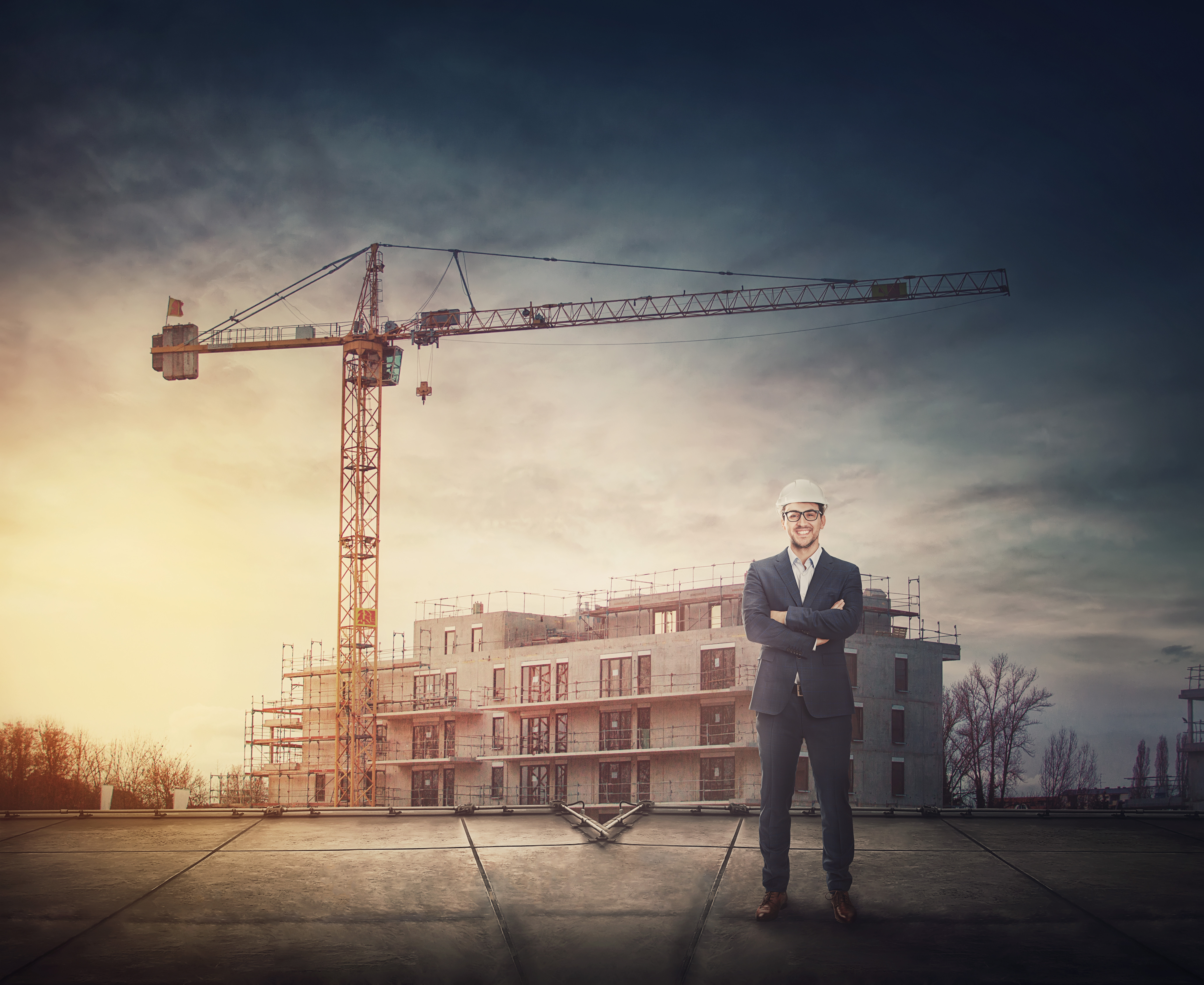 Construction manager standing in front of a building under construction