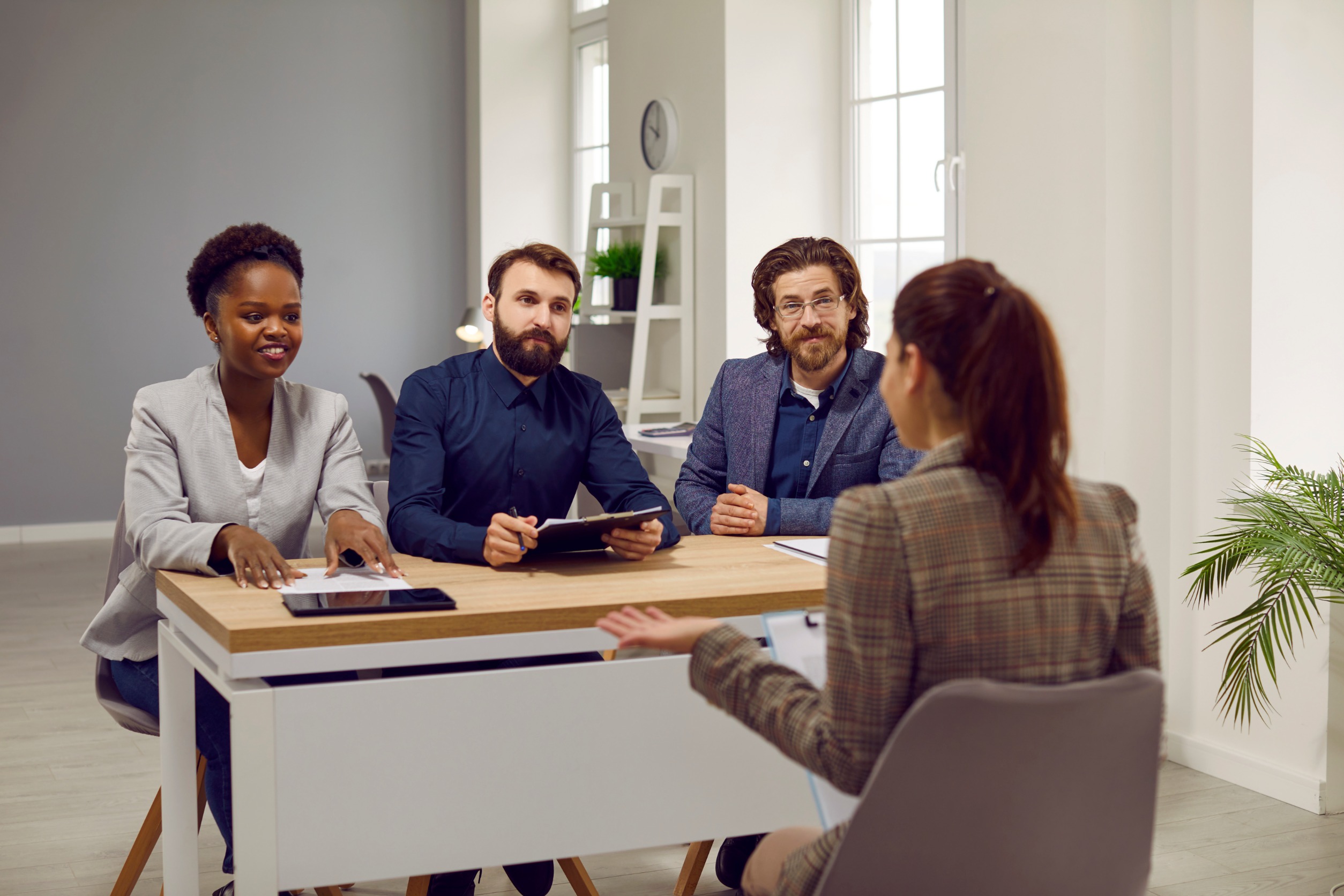 Job interview panel speaking with a candidate in an office